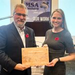 Michael Szemerda, Cooke Aquaculture accepting a plaque of recognition from MSA President Robyn McCallum.